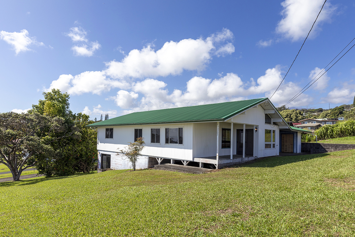 a view of a house with a backyard porch and sitting area