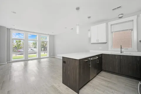 a kitchen with stainless steel appliances granite countertop a sink and wooden cabinets