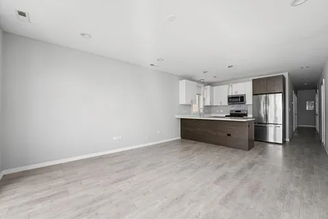 a kitchen with stainless steel appliances a refrigerator and a sink