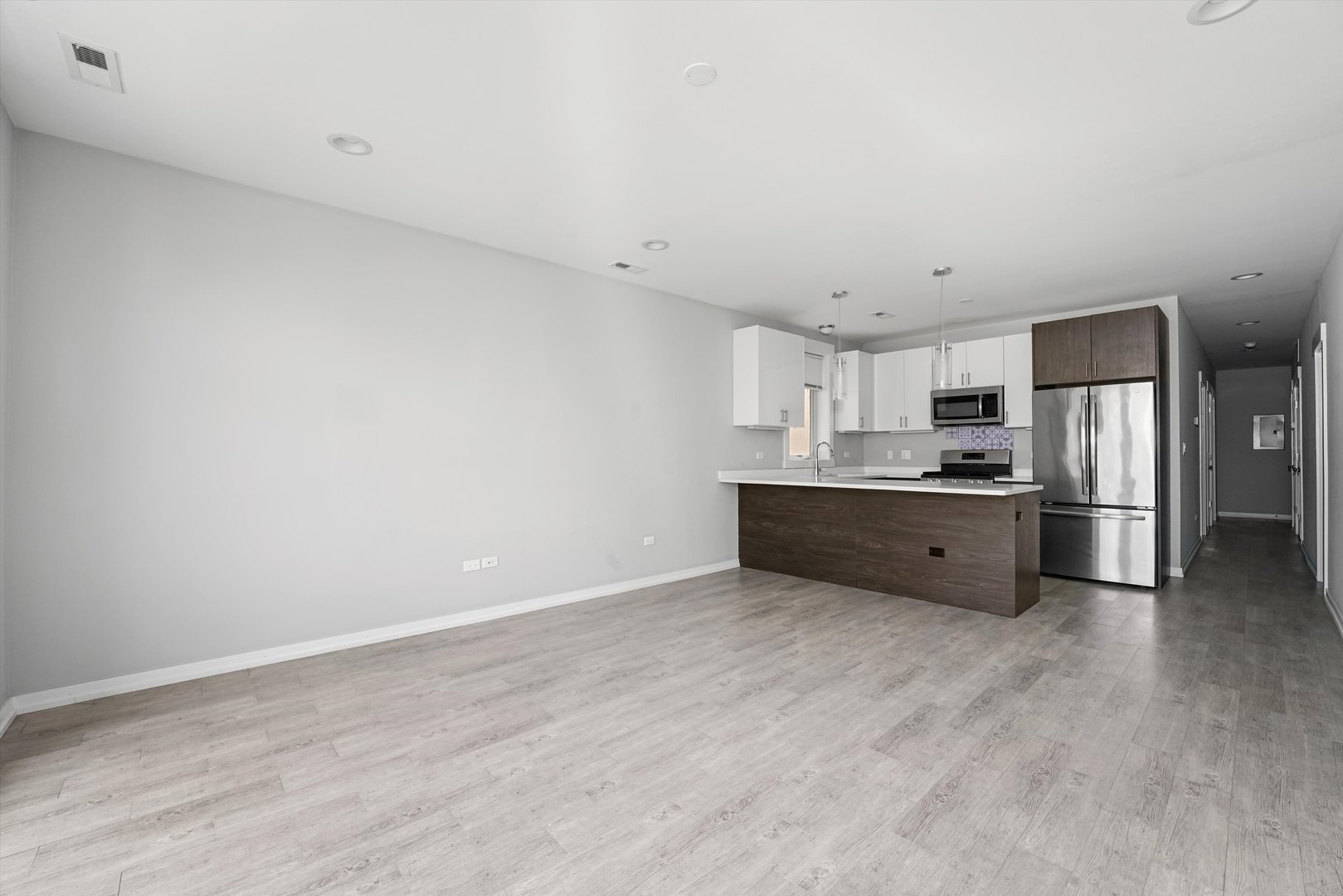 2529 West Congress Parkway, Unit 1 Chicago, IL 60612 - Photo 3 of 12 a kitchen with stainless steel appliances a refrigerator and a sink