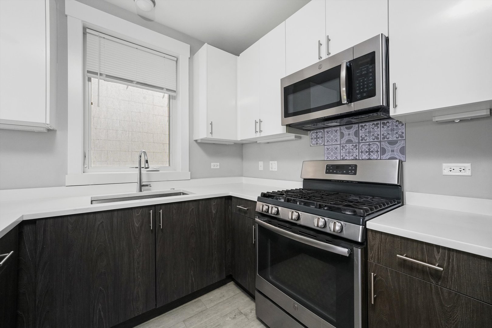 2529 West Congress Parkway, Unit 1 Chicago, IL 60612 - Photo 4 of 12 a kitchen with stainless steel appliances wooden cabinets and a stove top oven