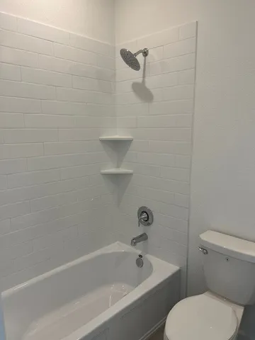 a kitchen with stainless steel appliances granite countertop a sink and a refrigerator