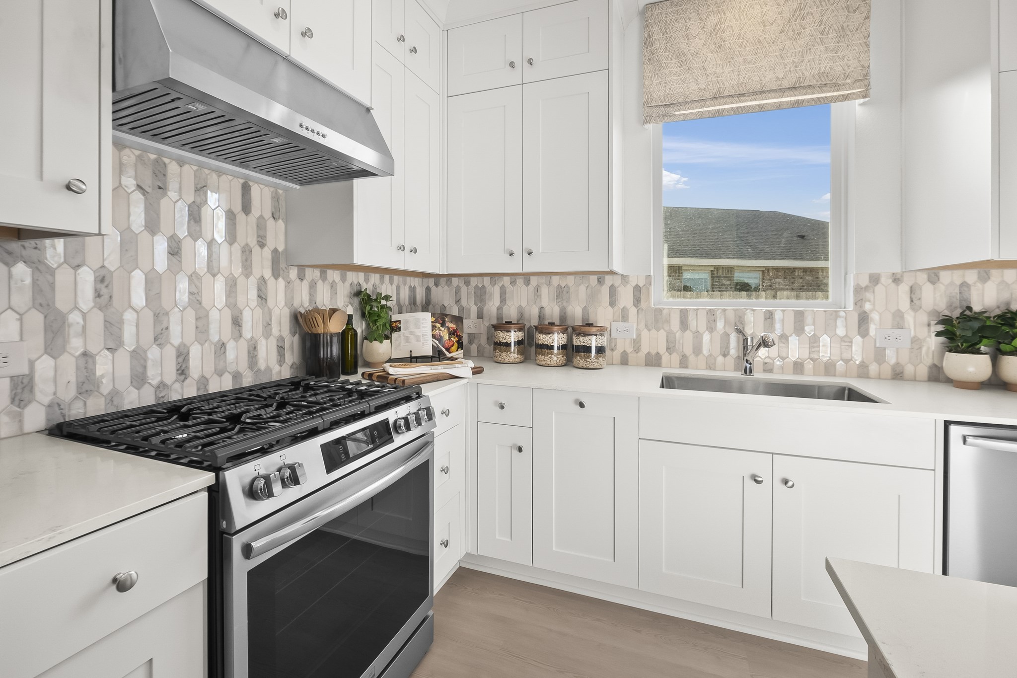 2134 Mosaic Vly Court Angleton, TX 77515 - Photo 7 of 27 a kitchen with white cabinets and appliances