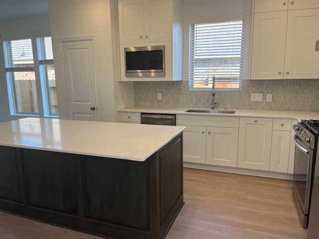 2134 Mosaic Vly Court Angleton, TX 77515 - Photo 16 of 27 a kitchen with a sink window and cabinets