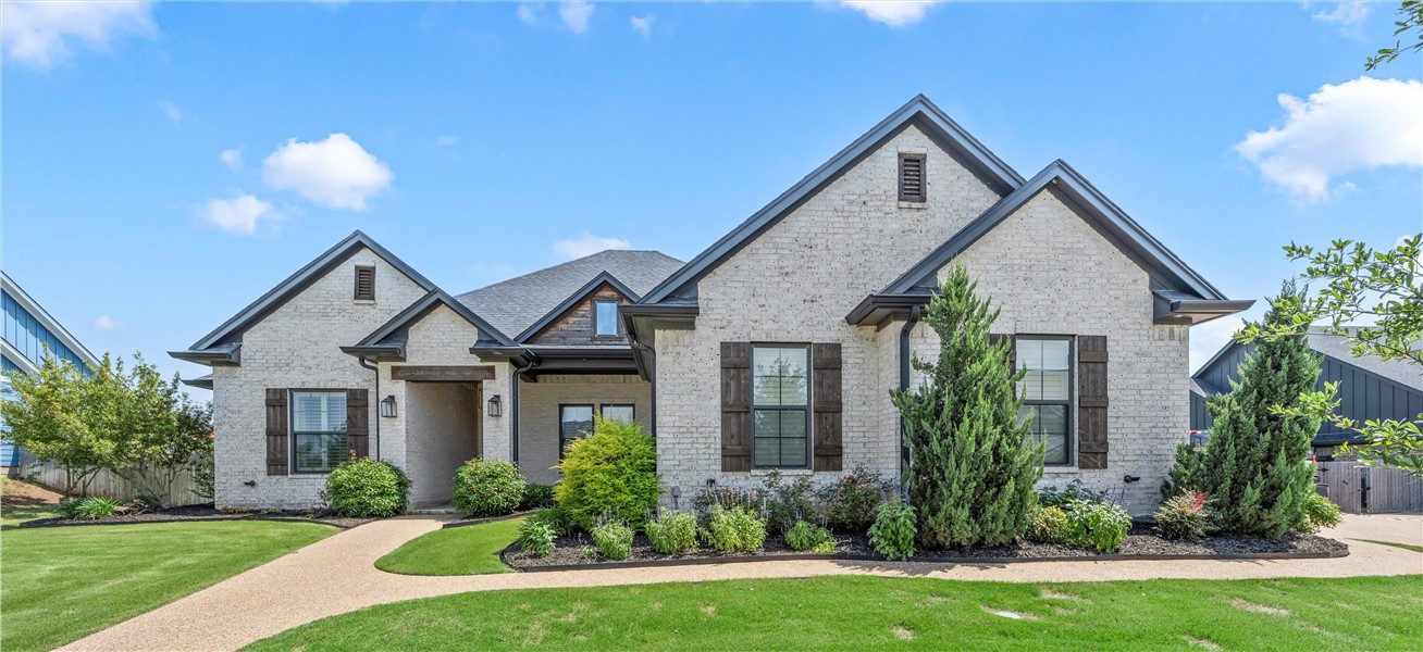404 Wycliff Drive China Spring, TX 76633 - Photo 1 of 1 a front view of a house with a yard and potted plants