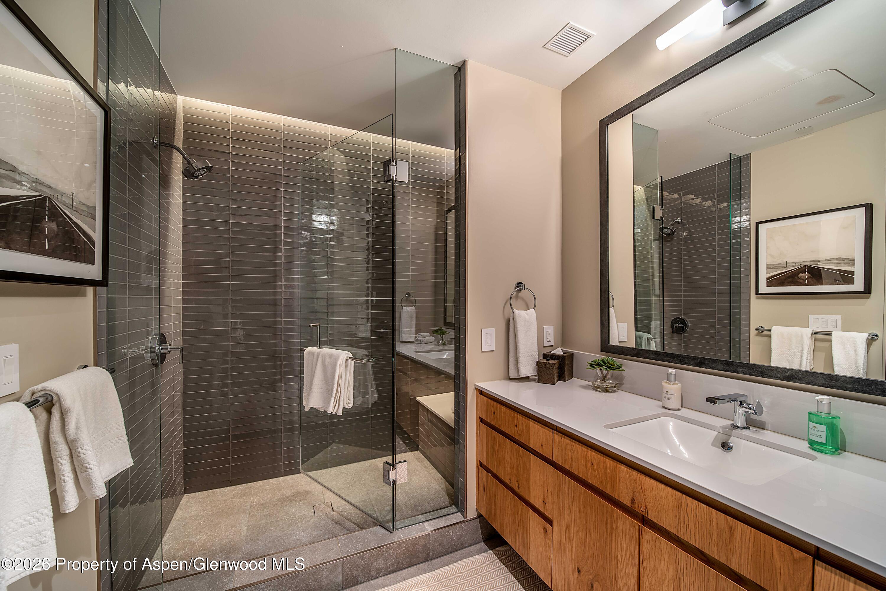 77 Wood Road, Unit 50711 Snowmass Village, CO 81615 - Photo 11 of 20 a bathroom with a sink and mirror