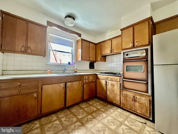 a kitchen with granite countertop cabinets stainless steel appliances and a sink