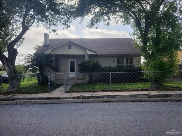 a house that has a tree in front of it