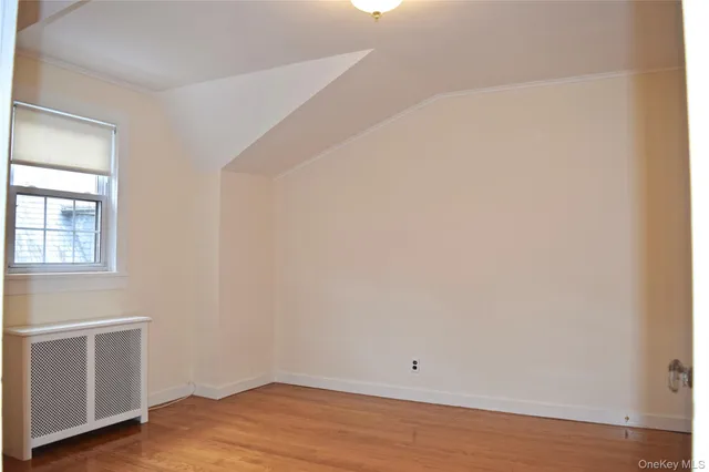 a view of a kitchen with wooden floor and electronic appliances