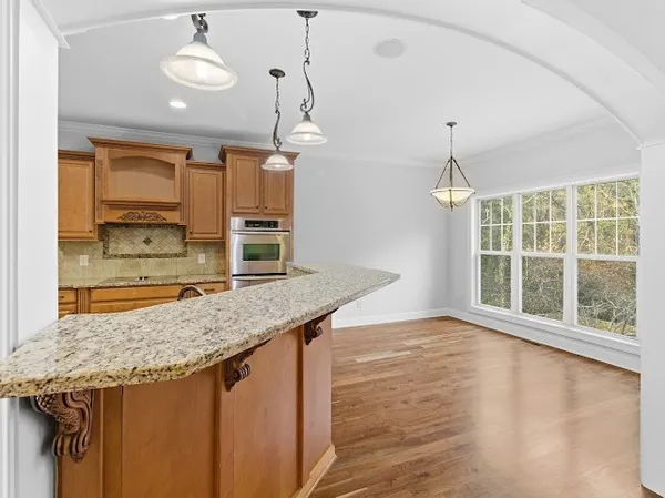 an empty room with a window and ceiling fan