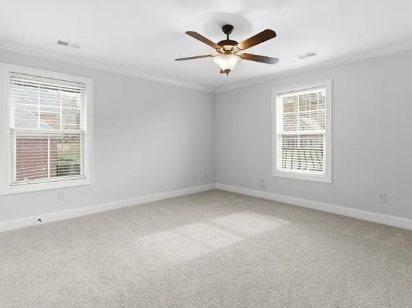 a view of a house with a yard and a tree