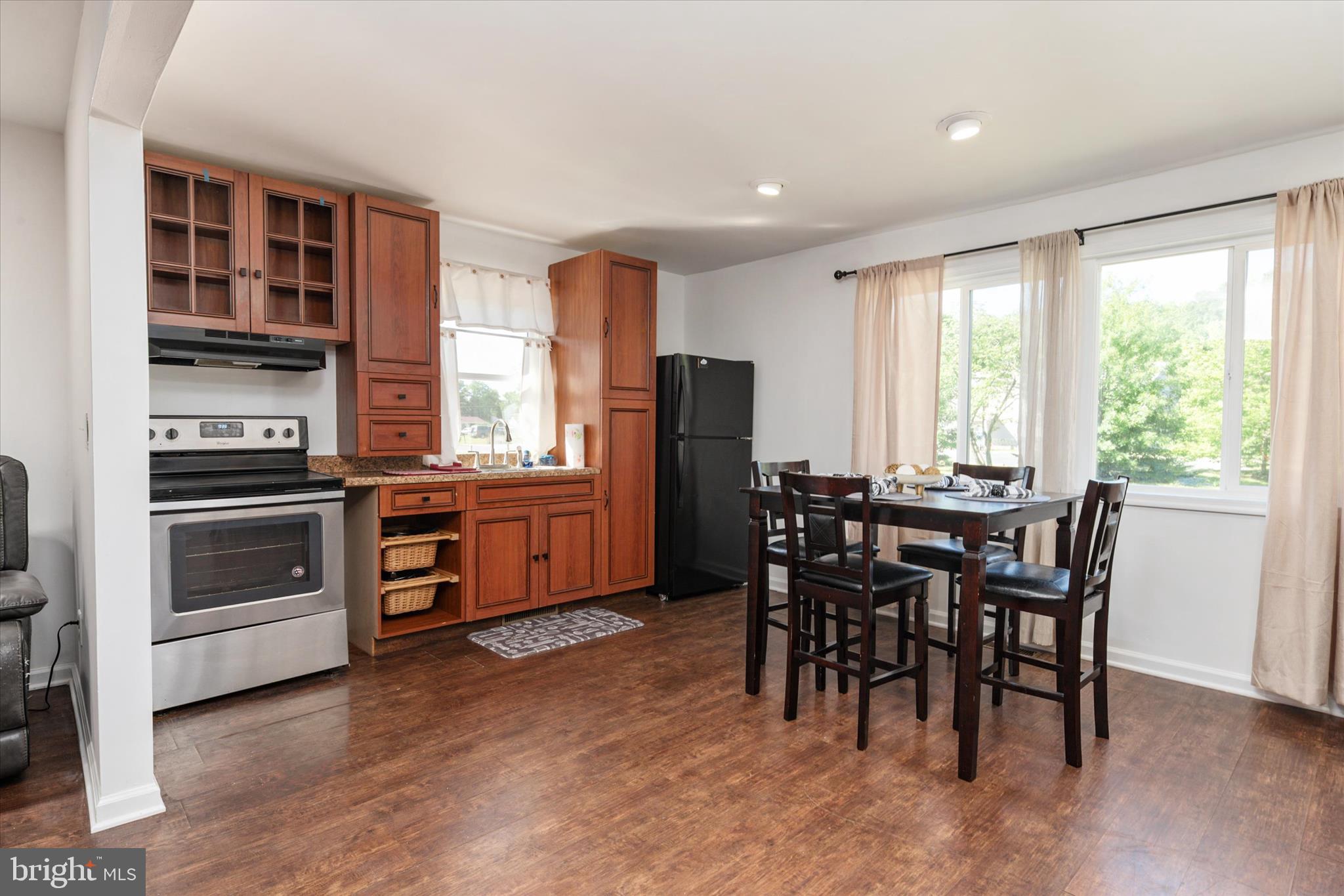 108 Wilson Road Grasonville, MD 21658 - Photo 29 of 38 a kitchen with a table chairs sink and refrigerator