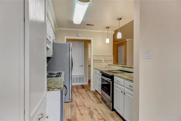 a view of a kitchen from the hallway