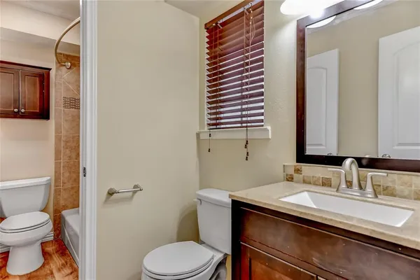 a bathroom with a sink toilet and mirror