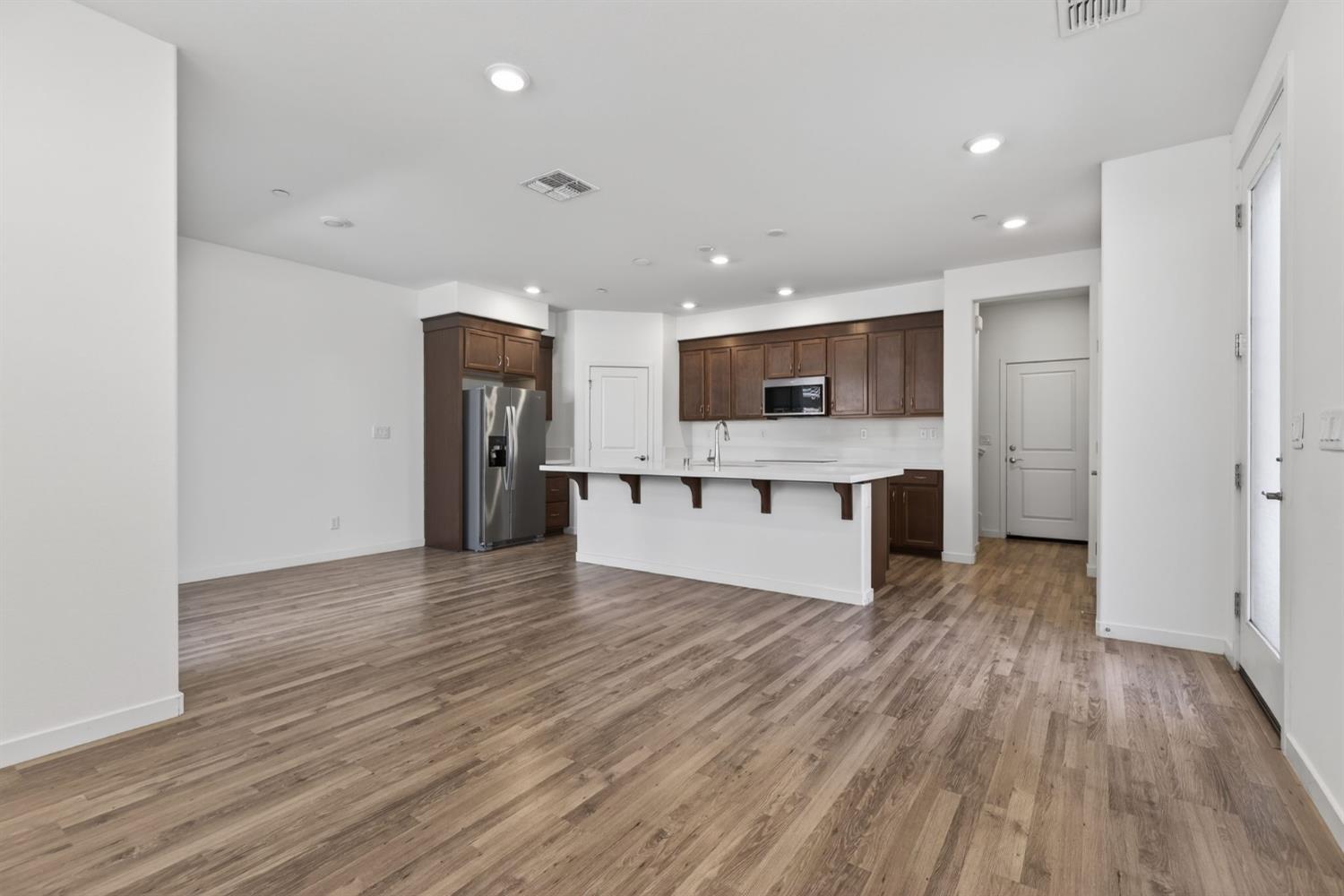 3080 Windwalker Walk Sacramento, CA 95833 - Photo 17 of 61 a view of kitchen with kitchen island granite countertop stainless steel appliances refrigerator and microwave
