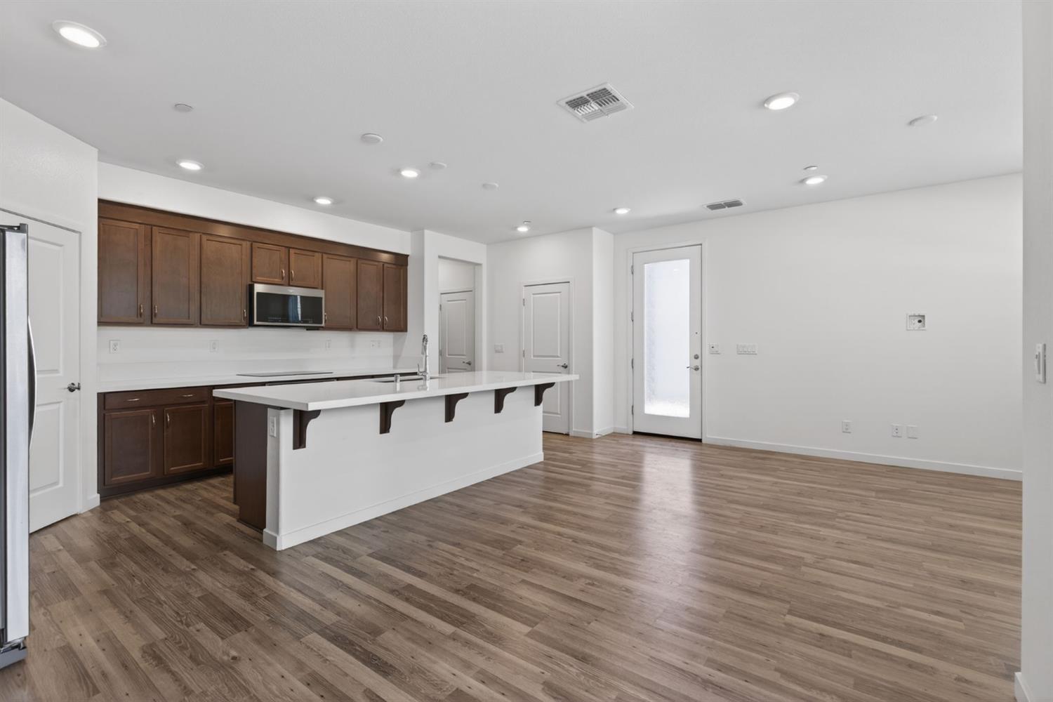 3080 Windwalker Walk Sacramento, CA 95833 - Photo 22 of 61 a large kitchen with stainless steel appliances granite countertop a large counter top and wooden floors