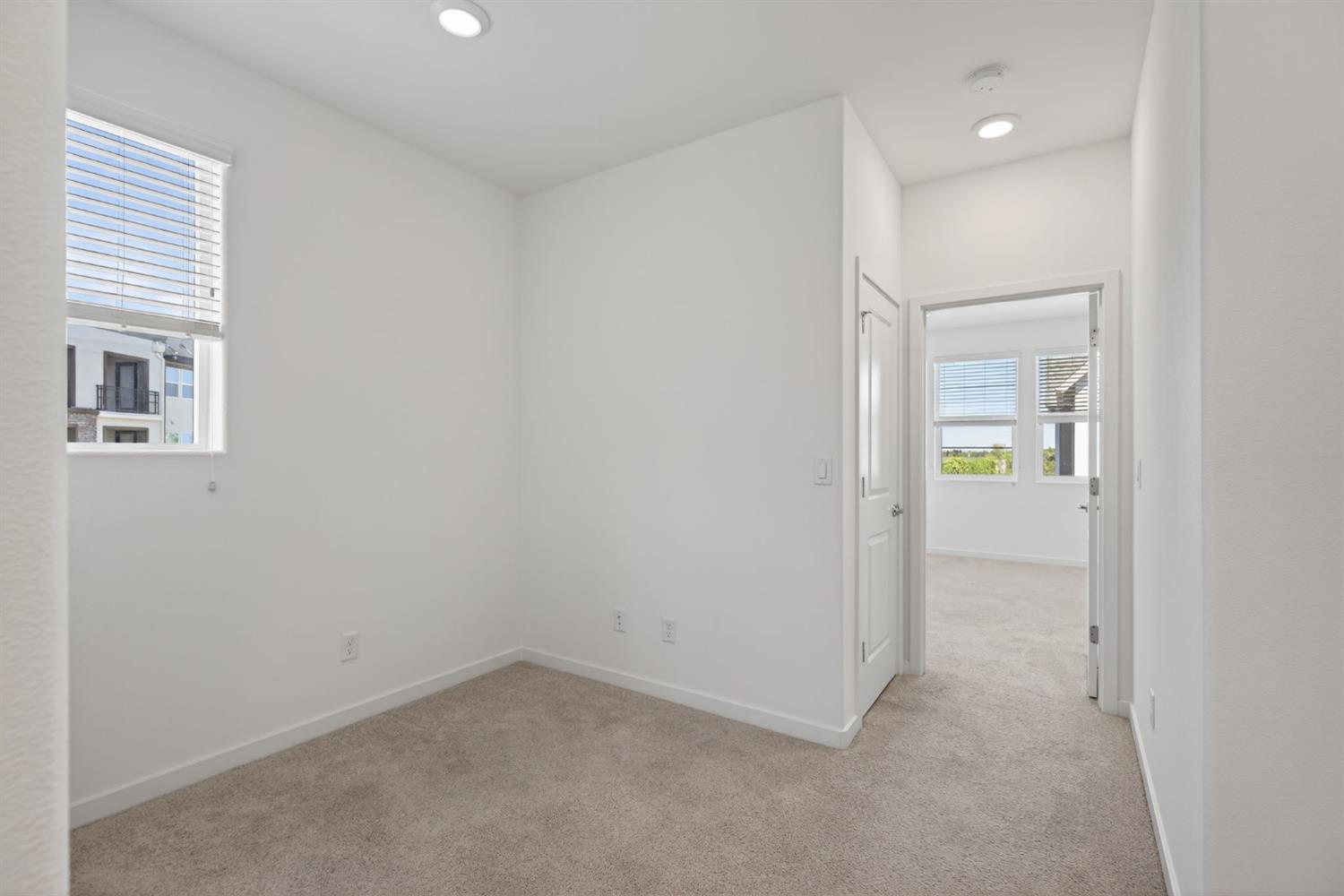 3080 Windwalker Walk Sacramento, CA 95833 - Photo 29 of 61 an empty room with windows and entrance to other room