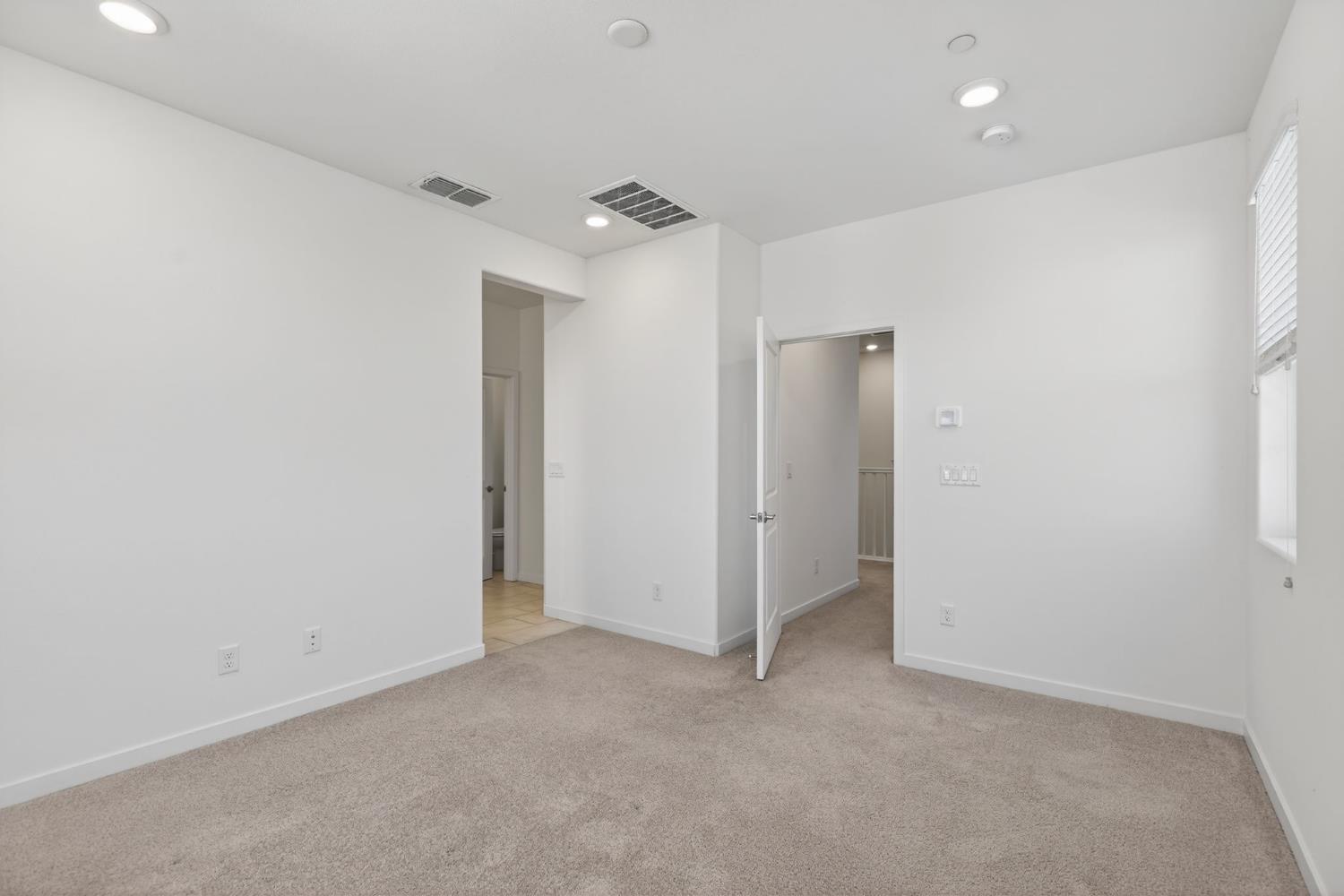 3080 Windwalker Walk Sacramento, CA 95833 - Photo 31 of 61 an empty room with closet and a ceiling fan