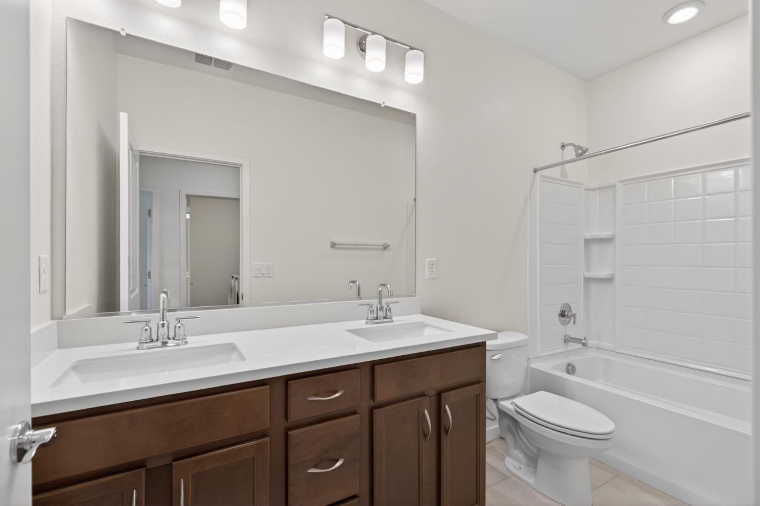 3080 Windwalker Walk Sacramento, CA 95833 - Photo 42 of 61 a bathroom with a double vanity sink toilet and a mirror