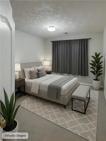 a bedroom with a bed and a potted plant