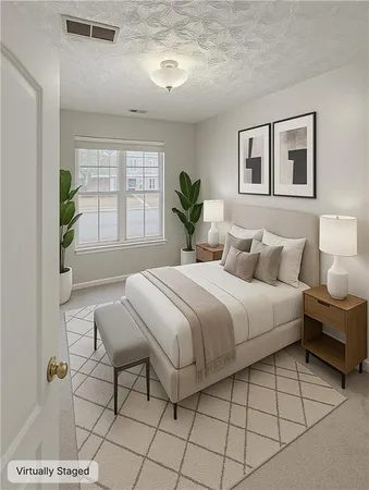 a spacious bedroom with a bed and a window