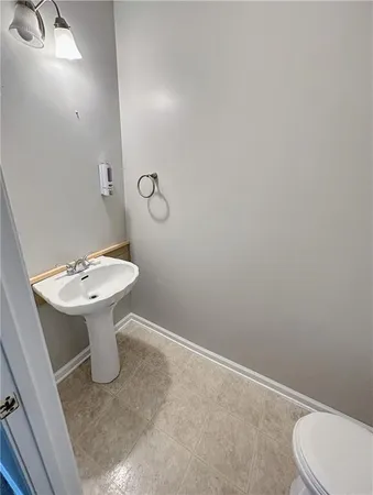 a bathroom with a sink a toilet and mirror