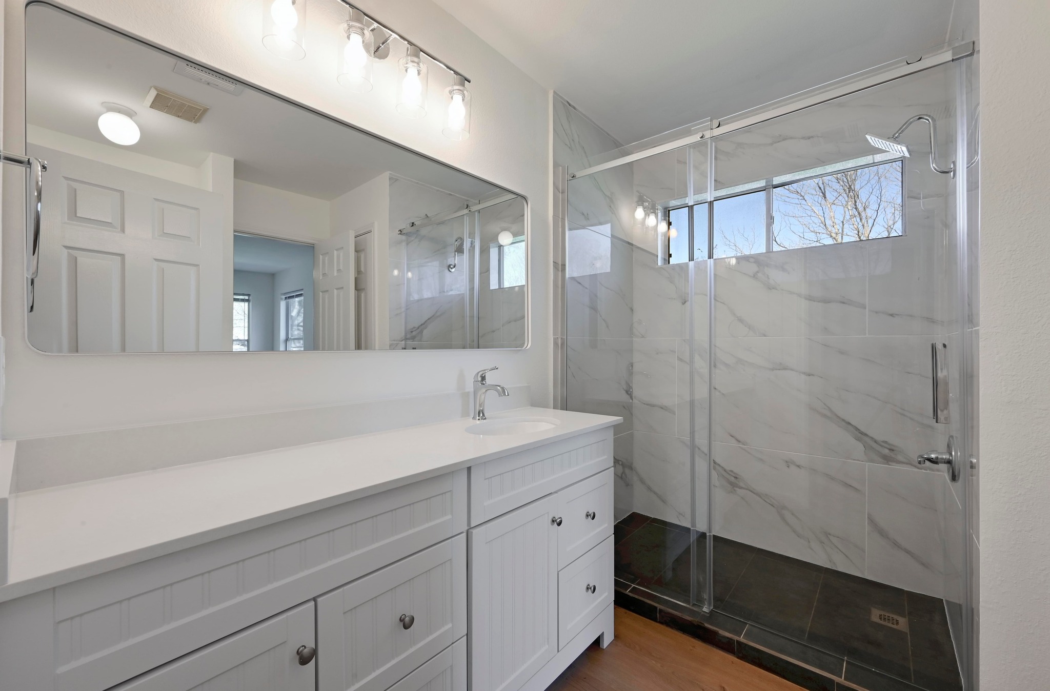 11106 Franklins Tale Loop Austin, TX 78748 - Photo 16 of 25 Bathroom featuring vanity, a marble finish shower, and plenty of natural light