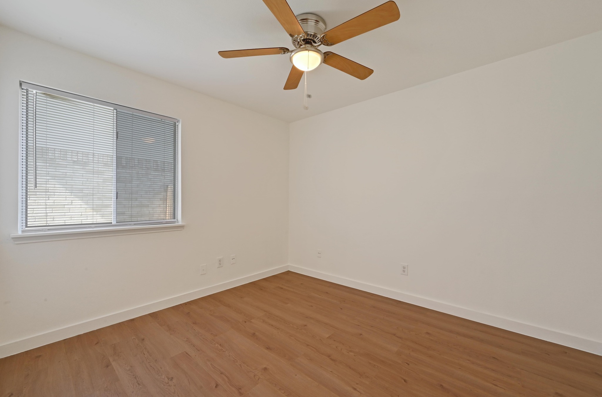 11106 Franklins Tale Loop Austin, TX 78748 - Photo 18 of 25 Empty room with wood finished floors and ceiling fan