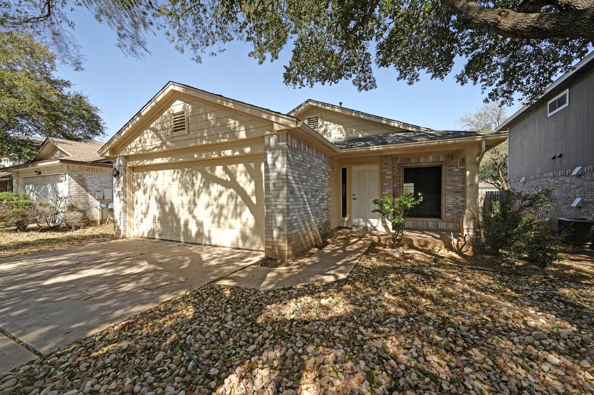 11106 Franklins Tale Loop Austin, TX 78748 - Photo 2 of 25 Ranch-style home featuring brick siding, a garage, and concrete driveway