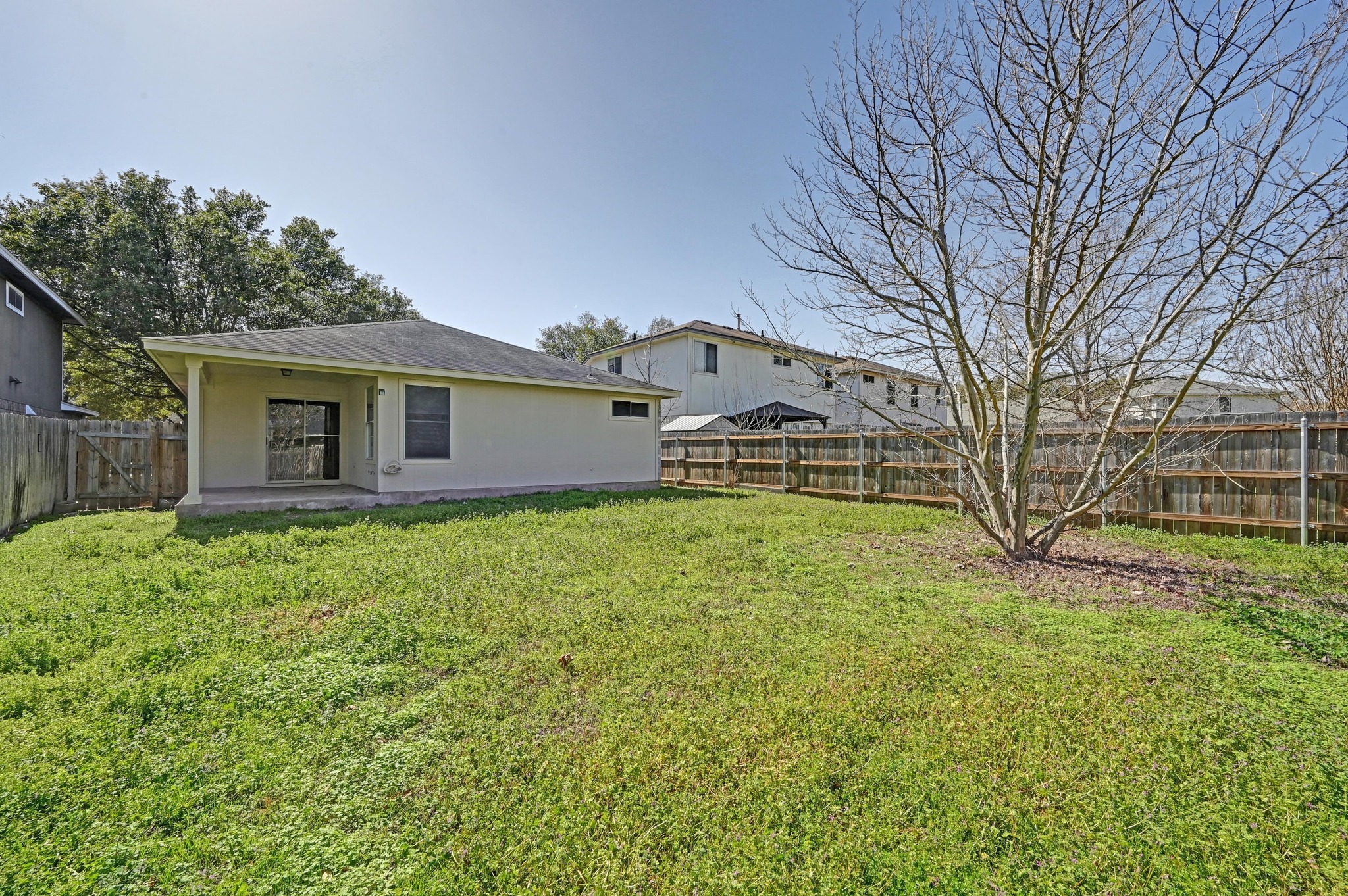 11106 Franklins Tale Loop Austin, TX 78748 - Photo 24 of 25 Rear view of house featuring a patio, a fenced backyard, and stucco siding