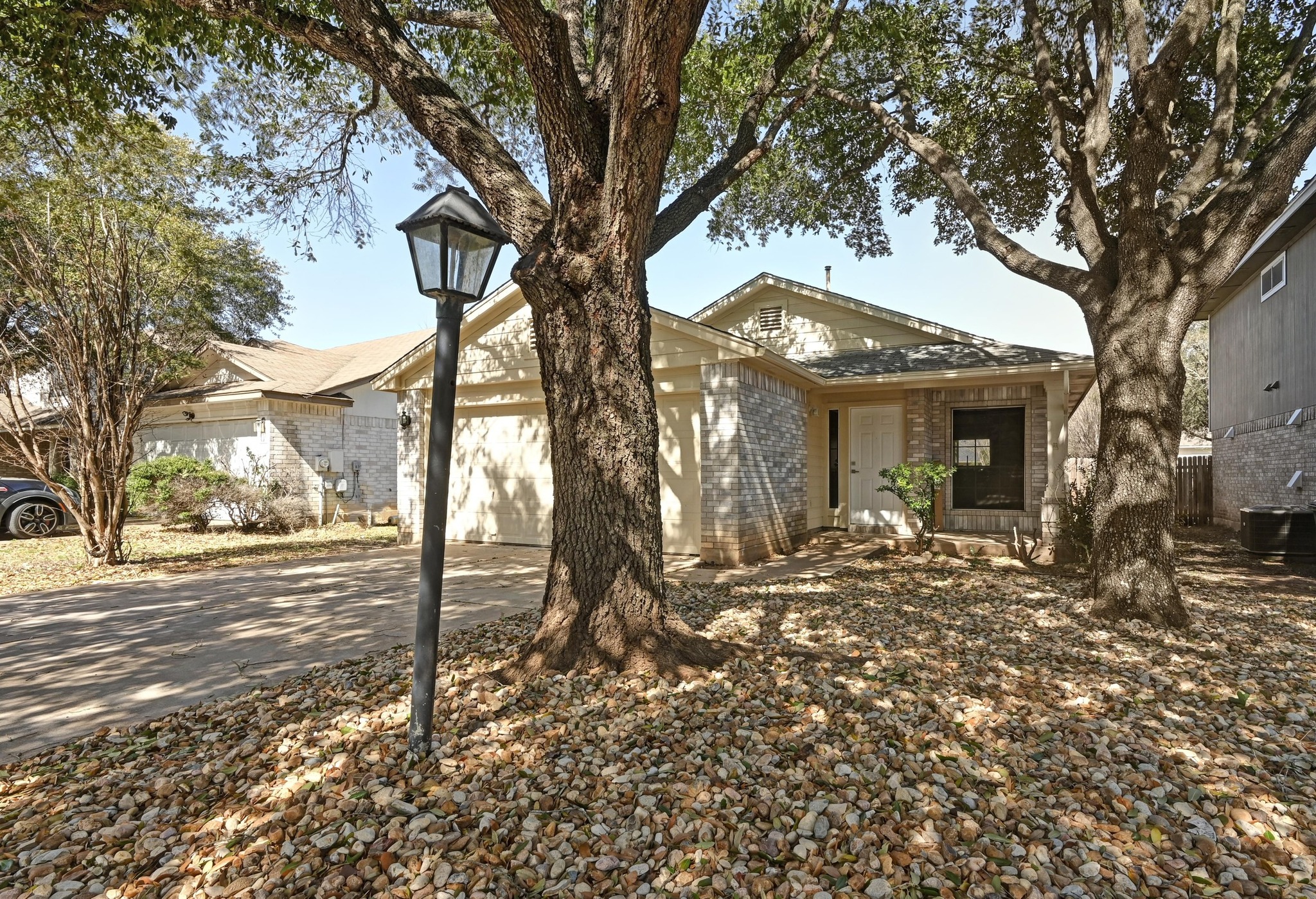 11106 Franklins Tale Loop Austin, TX 78748 - Photo 5 of 25 View of front facade with brick siding, a garage, and driveway