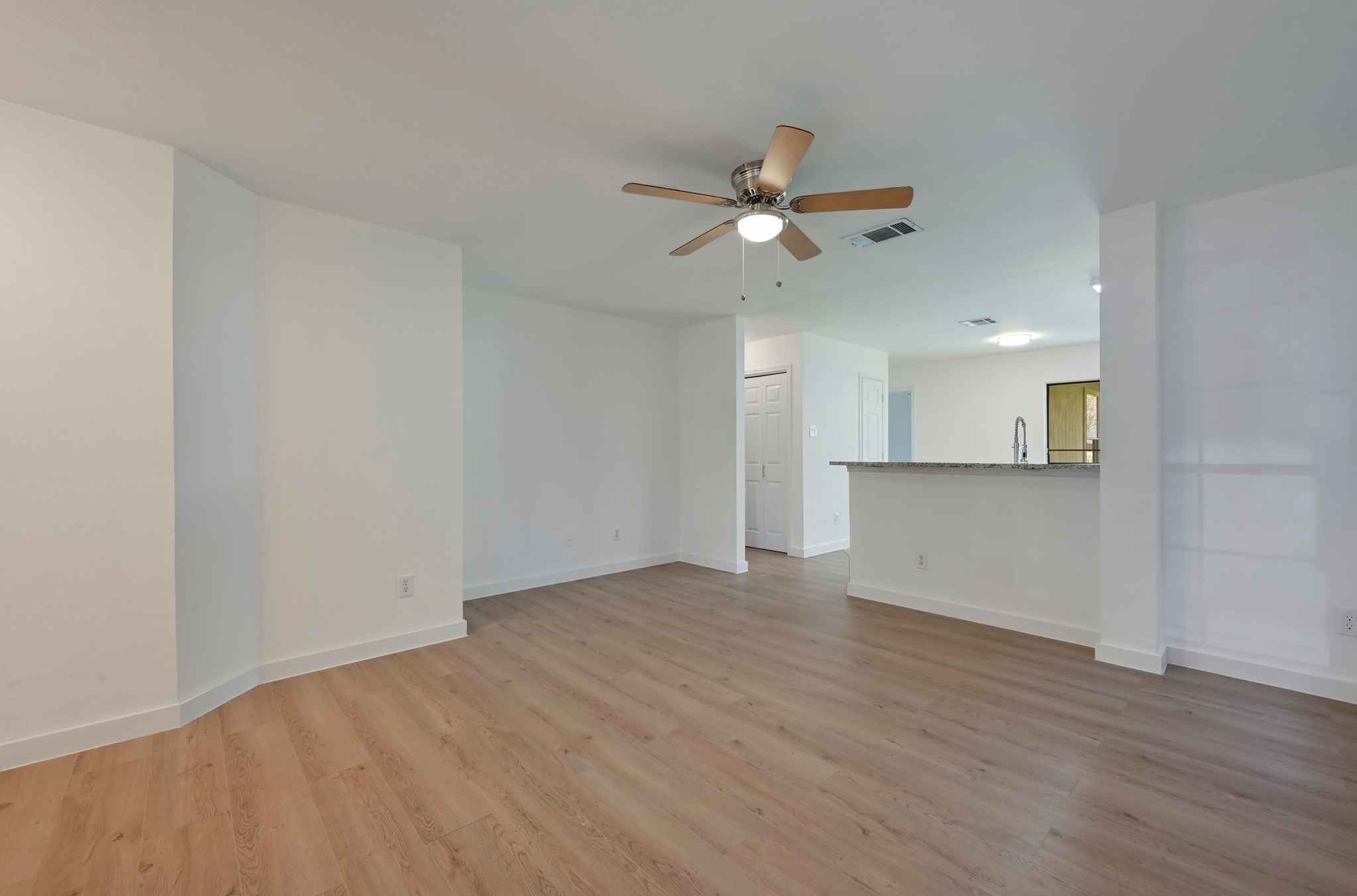 11106 Franklins Tale Loop Austin, TX 78748 - Photo 7 of 25 Unfurnished living room featuring ceiling fan and light wood-style floors