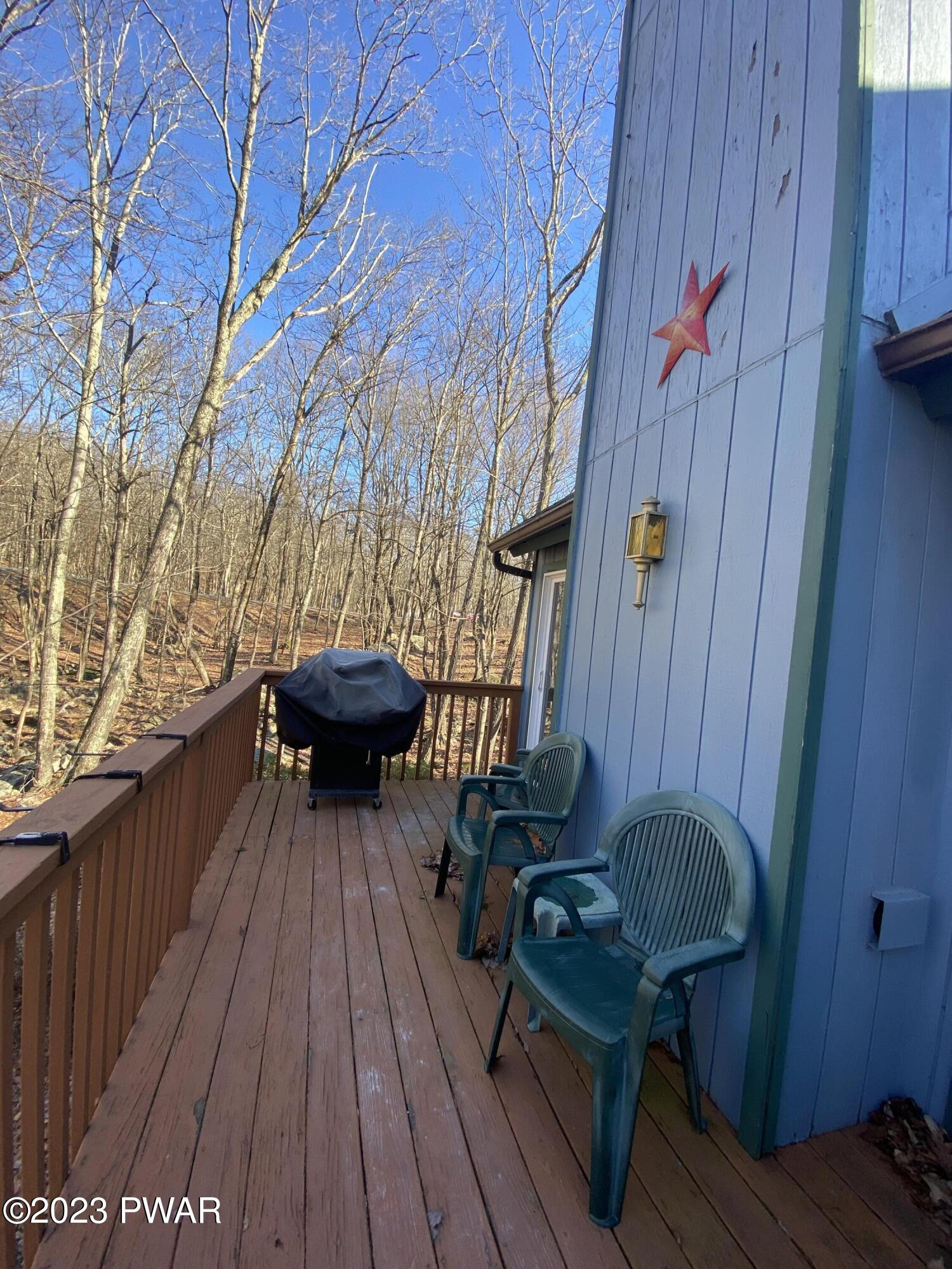 101 Maple Ridge Drive Hawley, PA 18428 - Photo 34 of 61 a view of balcony with wooden floor and outdoor seating