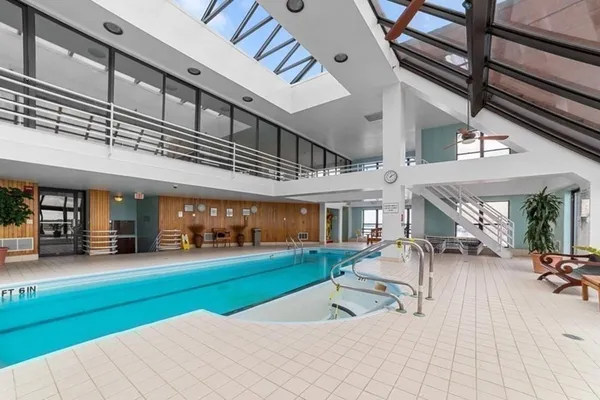 a swimming pool with outdoor seating and yard