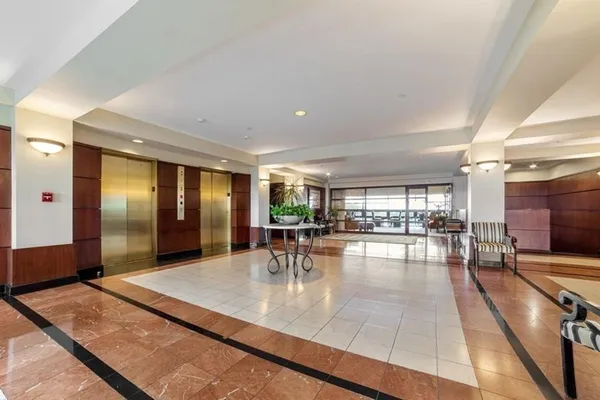 a lobby with furniture and dining table with kitchen view