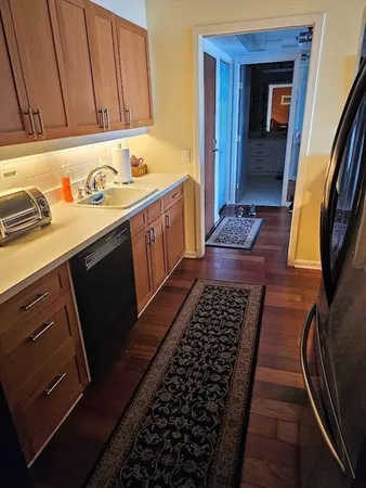 a kitchen with granite countertop a stove and a sink