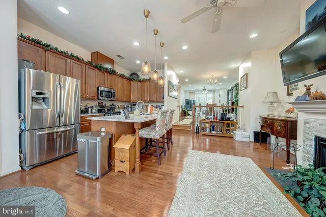 a kitchen with kitchen island a refrigerator and a dining table