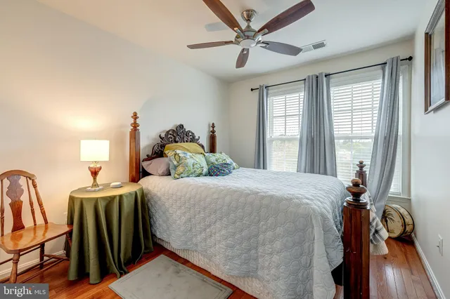 a living room with furniture a flat screen tv and a window