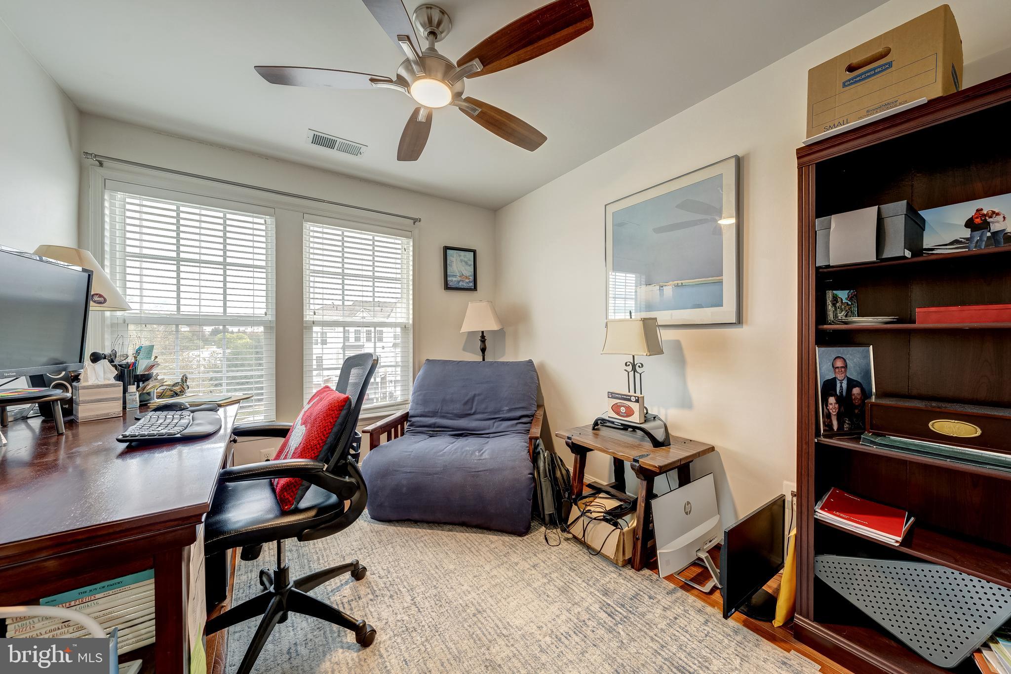 22644 Amberjack Square Brambleton, VA 20148 - Photo 27 of 34 a living room with furniture a flat screen tv and a window
