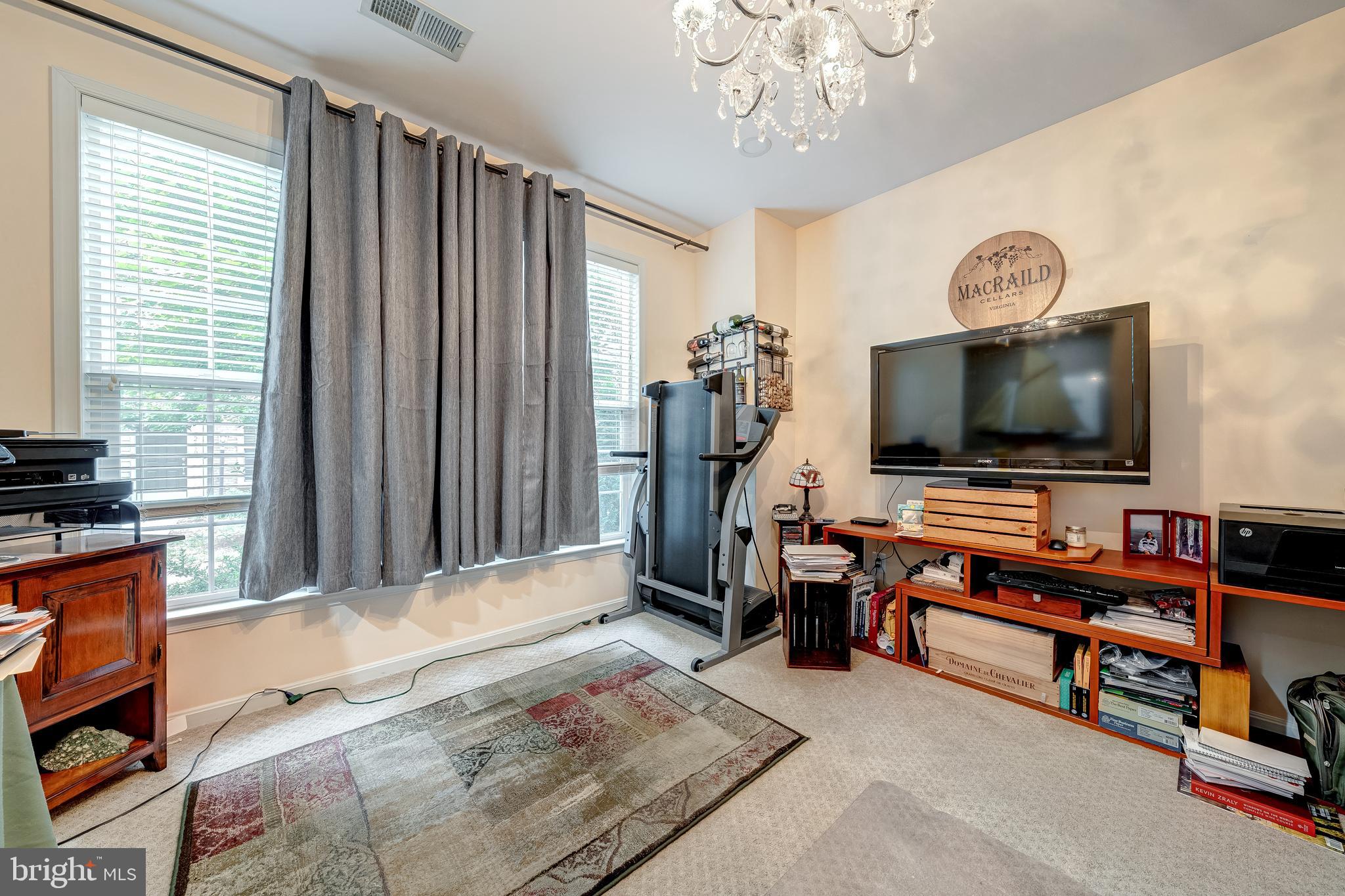 22644 Amberjack Square Brambleton, VA 20148 - Photo 30 of 34 a living room with furniture and a flat screen tv