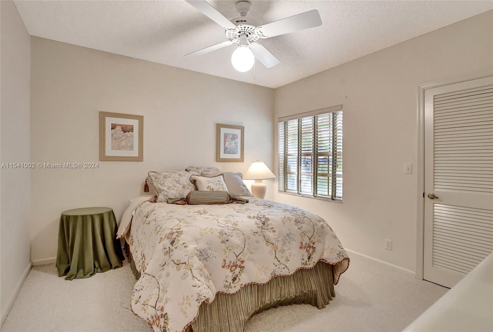 7602 Elm Ridge Drive, Unit 4L Boca Raton, FL 33433 - Photo 14 of 44 a bedroom with a bed and a window
