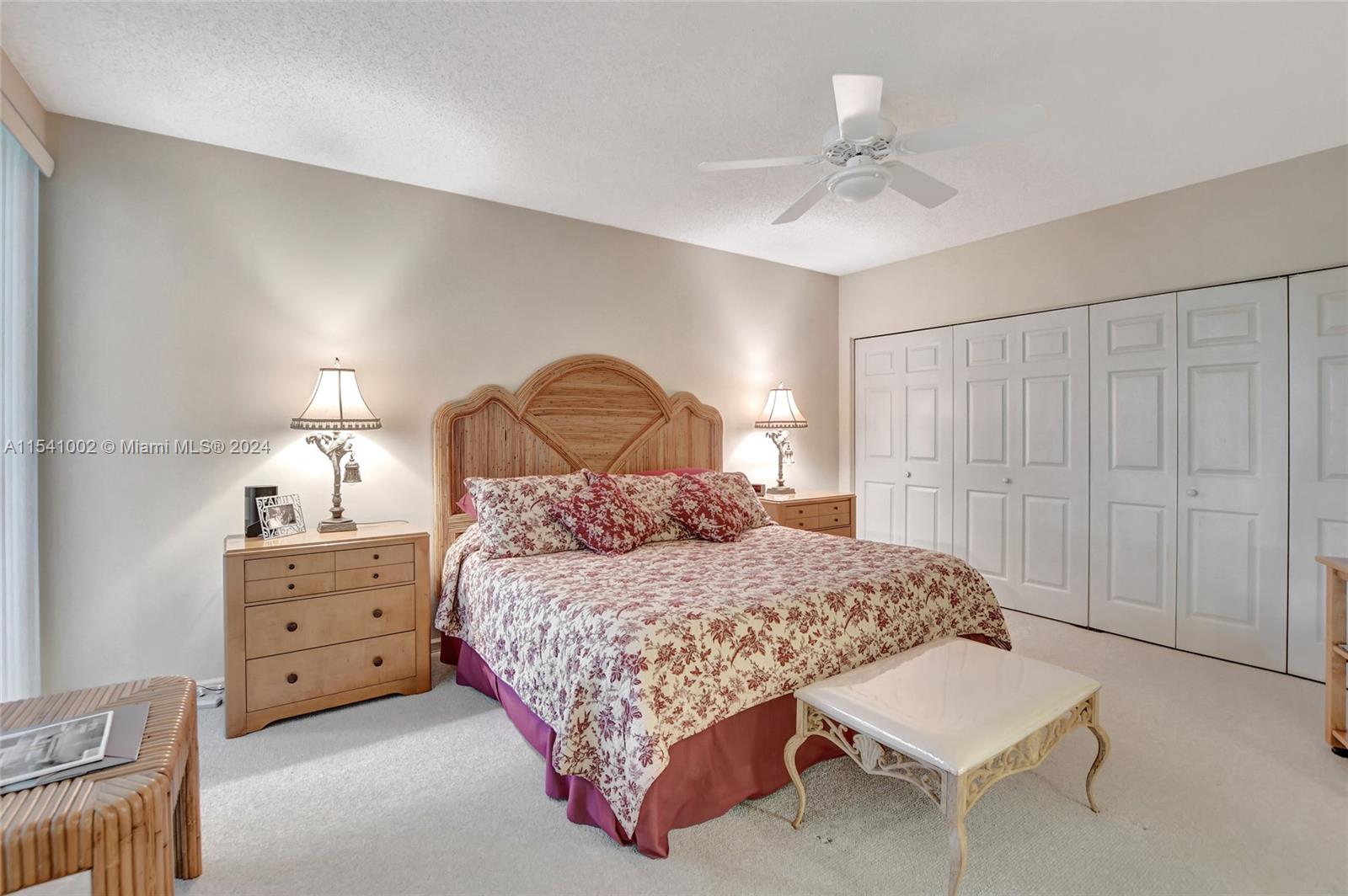 7602 Elm Ridge Drive, Unit 4L Boca Raton, FL 33433 - Photo 9 of 44 a bedroom with a bed and a chandelier