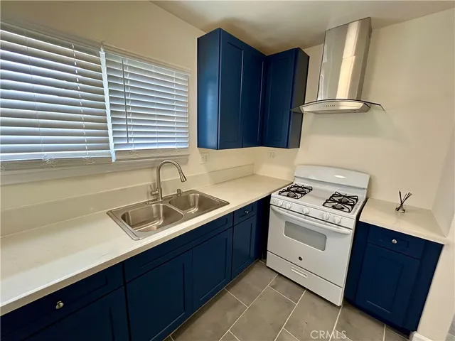 a kitchen with a sink cabinets and window