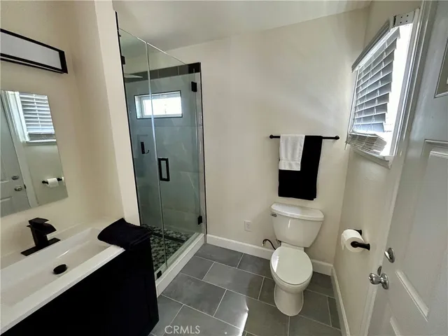 a bathroom with a shower and a sink