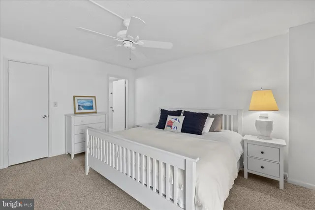 a bedroom with a bed a lamp and a chandelier