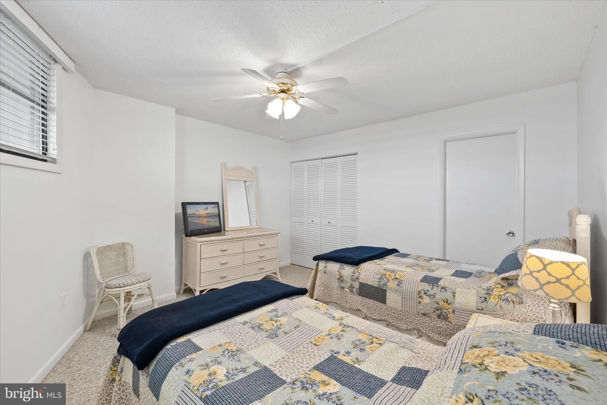603 North Edgewater House Road, Unit 603N Bethany Beach, DE 19930 - Photo 17 of 40 a bedroom with a bed and a chandelier