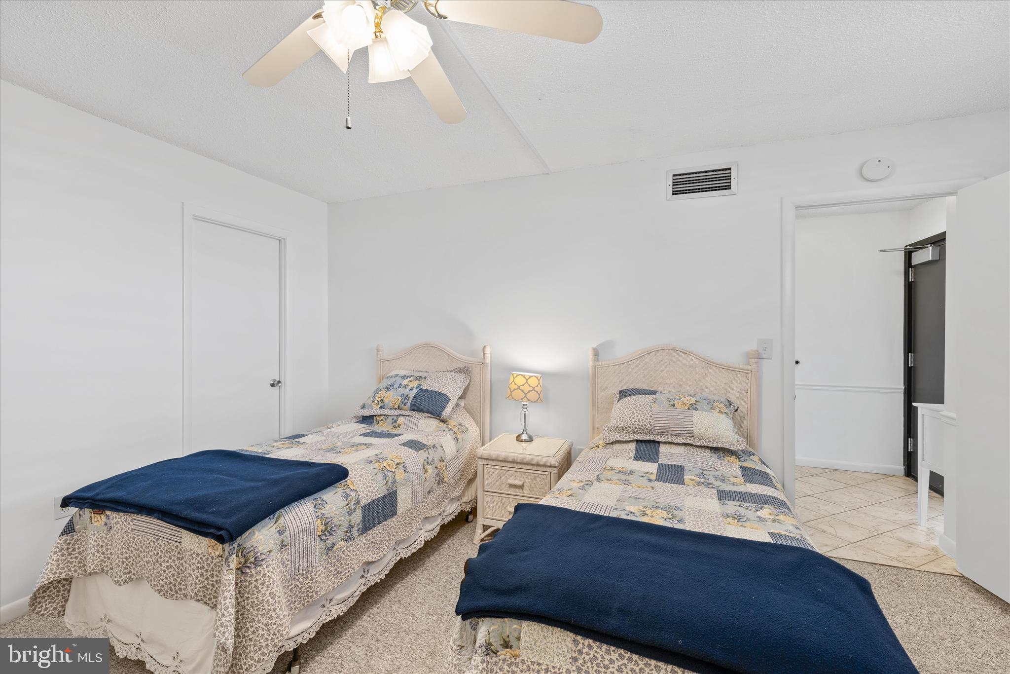 603 North Edgewater House Road, Unit 603N Bethany Beach, DE 19930 - Photo 18 of 40 a bedroom with bed and a chandelier