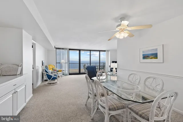 a living room with furniture a chandelier and a dining table
