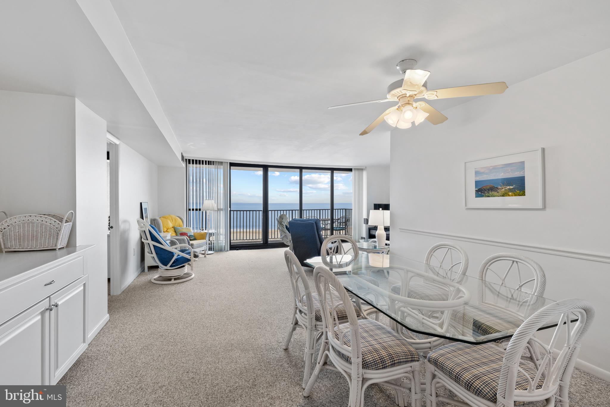 603 North Edgewater House Road, Unit 603N Bethany Beach, DE 19930 - Photo 3 of 41 a living room with furniture a chandelier and a dining table