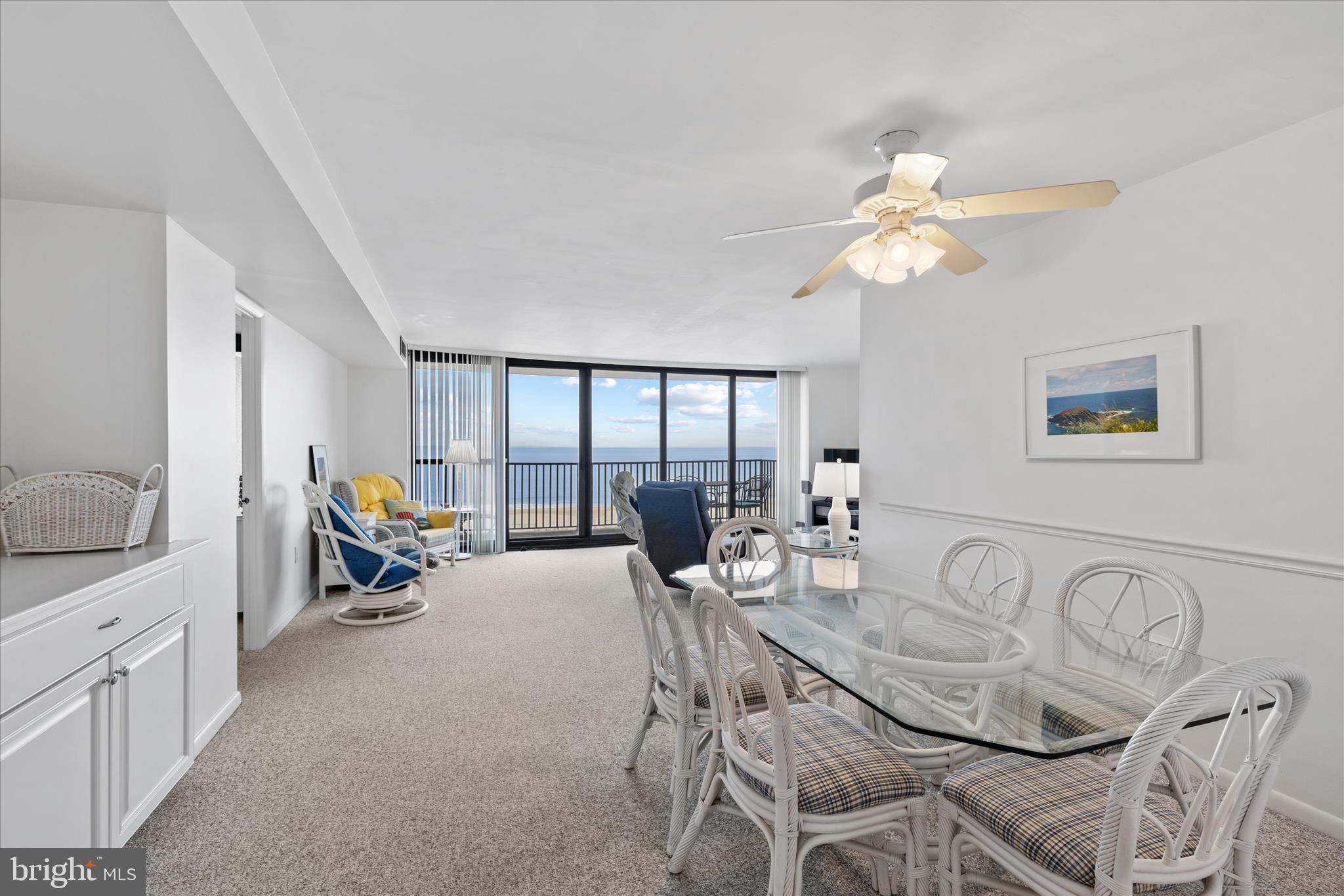 603 North Edgewater House Road, Unit 603N Bethany Beach, DE 19930 - Photo 4 of 40 a living room with furniture a chandelier and a dining table